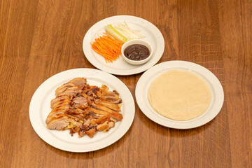 Chinese Recipe of Chopped Roasted Peking Duck with Sauce, Onion, Cucumber Strips and Carrots with Steamed Rice Tortillas