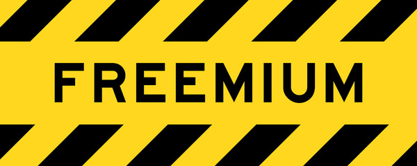 Yellow and black color with line striped label banner with word freemium