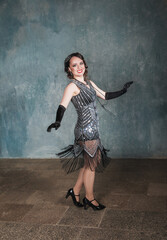 Beautiful happy woman in retro 20 – 30 style dancing