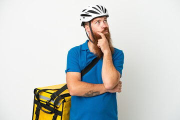 Young reddish caucasian man with thermal backpack isolate don white background having doubts