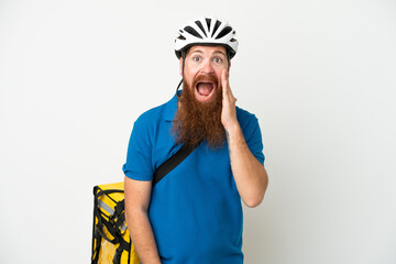 Young reddish caucasian man with thermal backpack isolate don white background with surprise and shocked facial expression