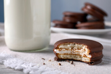 Tasty choco pie and milk on white napkin, closeup view