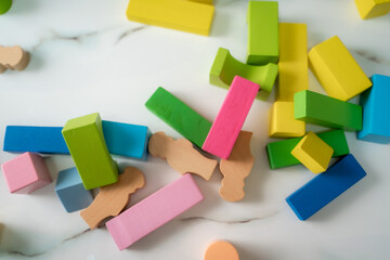 Top view on multicolor toy bricks on white wooden background,Educational toys for child.