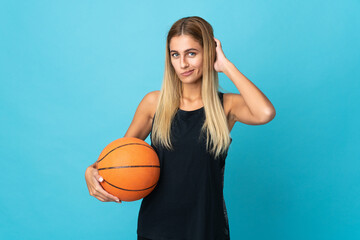 Young woman playing basketball  isolated on white background having doubts