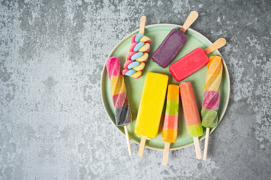 colorful ice cream popsicles on dark backrgound