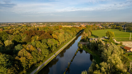 Aerial view the river on green forest plain. Amazing aerial shot of beautiful blue river. Forest background. High quality photo