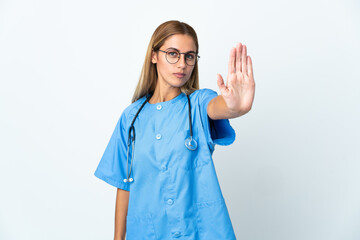 Surgeon doctor woman over isolated white background making stop gesture