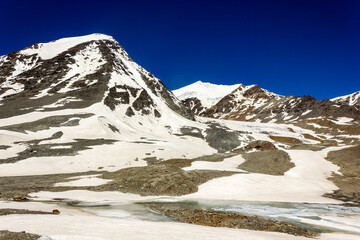 Beautiful landscape of snow capped mountain peaks at the edge of a glacier on the remote wilderness...