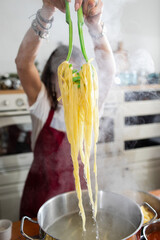 Italian cuisine at home. Making pasta. Chef's hands and pasta