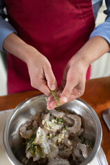 Thyme in the chef's hands. Cooking technology of Mediterranean cuisine. Peeled shrimp bowl