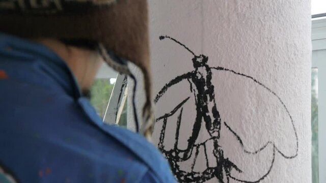 Artist Painting Mural Outdoors.