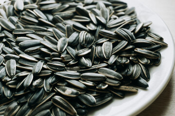 close-up of sunflower seeds on a white background- raw material for the production of sunflower oil