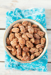 caramelized almonds on white wooden surface