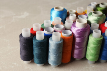 Set of color sewing threads on light grey table