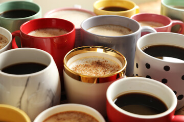Many cups of different coffees on table, closeup