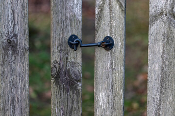 old weathered wooden fence with metal lock as background