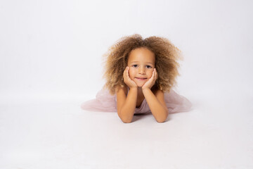 Beautiful little ballerina over a white background