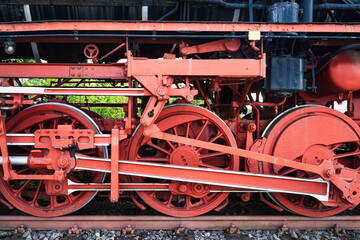 Red wheels and drive mechanism of an old steam locomotive