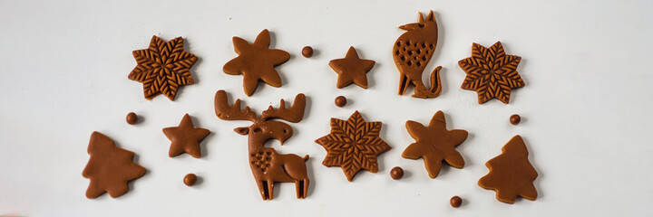 Pattern of Christmas gingerbread cookies in the form of animals, trees, snowflakes