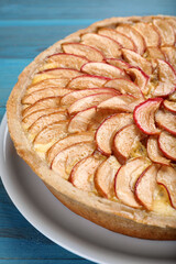 Tasty apple pie on light blue wooden table, closeup