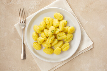Potato dumplings gnocchi mediterranian food. Cooked gnocchi with butter and green onions.