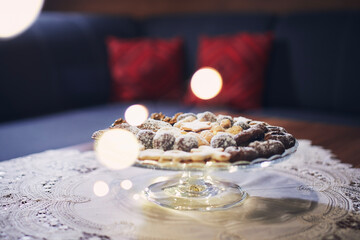 Traditional Christmas cookies with decorations on table at living room..