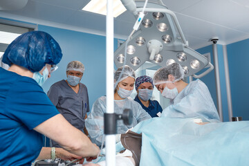 Concentrated Surgical team operating a patient in an operation theater. Well-trained anesthesiologist with years of training with complex machines follows the patient throughout the surgery