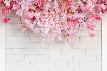 Flower texture background for wedding scene. Flowers on white brick wall with free space for text....
