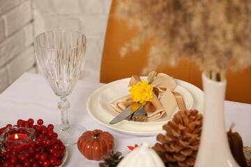 Beautiful autumn place setting and decor for festive dinner on table