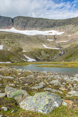Fototapeta na wymiar Mountain valley with a lake and a glacier on the mountain in the wilderness