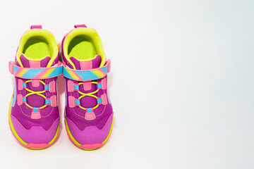 color kid  sneakers shoes on floor top view soft focus copy space