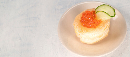 banner with Appetizer with red caviar. Tartlets, red caviar, cucumber on a white background with space for your text. Delicious and healthy snack. Top view.
