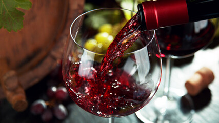 Macro shot of pouring red wine into glass.