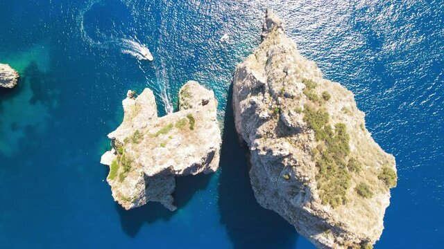 Amazing aerial view of Faraglioni Rocks over the sea in Capri Island, Italy. Drone viewpoint