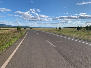 Road through green fields