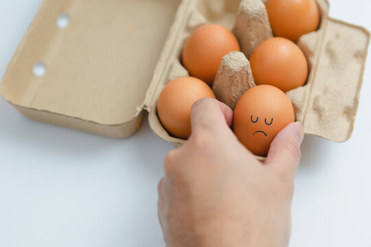 His hands would pick up brown eggs arranged in boxes with sad and lonely faces. to cook