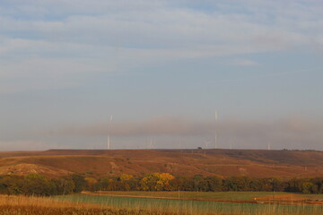 Electrical Wind Mills hiding behind low clouds