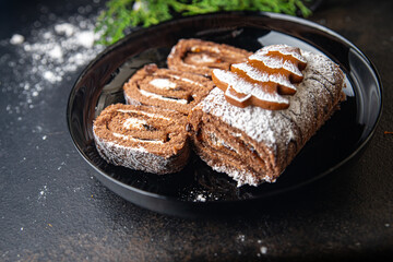 christmas cake roll chocolate white cream new year meal snack on the table copy space food background rustic 
