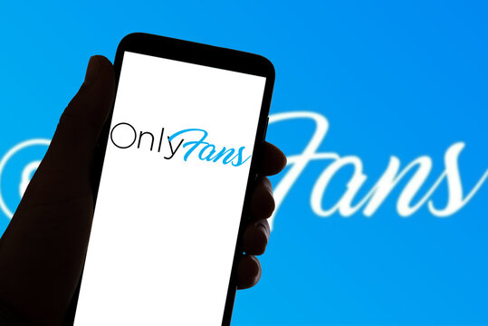 In this photo illustration the logo of the social network OnlyFans is seen on the screen of mobile phone and of a laptop in Barcelona, Spain on November 4, 2021.