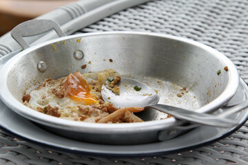 Vietnamese food, fried egg on aluminum pan after eating.