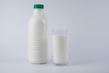 Bottle and glass of kefir, yogurt or milk isolated on white background with copy space