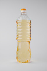 Plastic bottle of vegetable sunflower olive oil isolated on white background, flat lay
