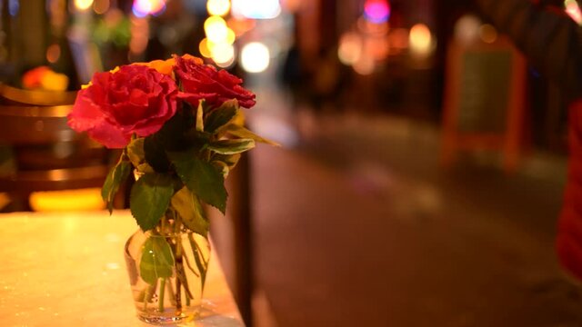 Flowers on a Table of Street Restaurant, Latin Quarter of Paris at Night Lights