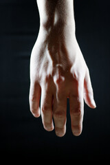a large part of the hand on a black background