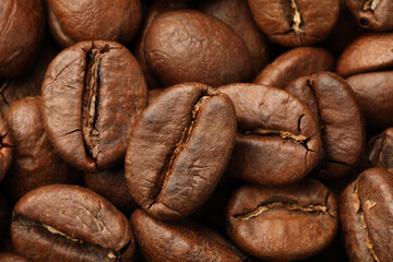 Pile of roasted coffee beans as background, closeup