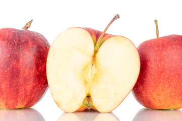 One half and two whole sweet juicy apples, close-up, isolated on white.