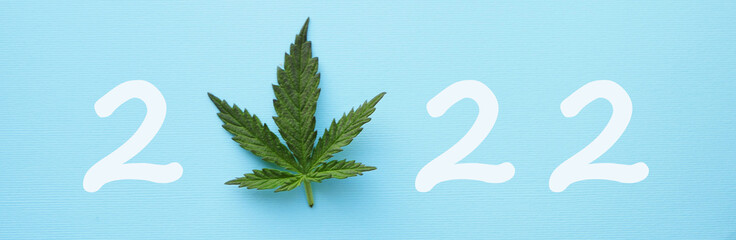 2022 with Cannabis leaf top view. Happy new year banner. Marijuana legalization