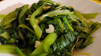 Chinese traditional dish from southeast region, green leaves of pak choi with garlic, plain without...