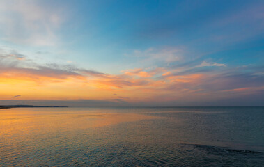 Colored clouds over the sea at sunset