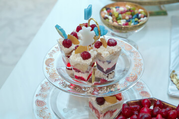 Meringue with strawberries, figs, raspberries and blueberries. Delicious desserts at wedding candy bar . top raspberry white cake . Meringue with summer berries and fruits.